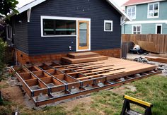 a house that is being built with wooden decking