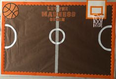 an orange and brown paper bag with basketballs on it, in front of a hoop