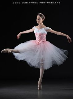 a ballerina in pink and white is posing for the camera