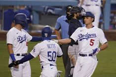 two baseball players are congratulating each other on the field