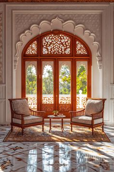 two chairs sitting in front of an arched window