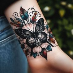 a woman's arm with a butterfly and flower tattoo design on the left wrist