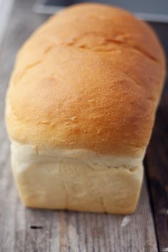 a loaf of bread sitting on top of a wooden table