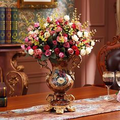 a vase filled with flowers on top of a wooden table