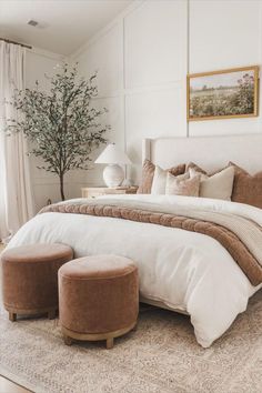 a large bed sitting in a bedroom on top of a rug next to a window