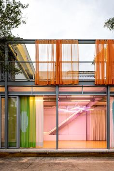 the inside of a building with colorful curtains