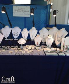 there are many necklaces on display at the booth