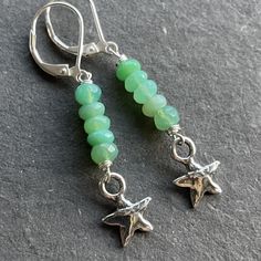 Bright beautiful faceted chrysoprase wired in sterling silver show off a sweet solid sterling silver artisan star. The approximate length is 1 7/8". The leverbacks shown are an upgrade. Please choose your earwire preference. Your jewelry will arrive beautifully giftboxed. Handmade Green Star-shaped Jewelry, Green Star-shaped Handmade Jewelry, Nickel-free Chrysoprase Jewelry Gift, Nickel-free Silver Chrysoprase Jewelry, Adjustable Silver Jewelry With Chrysoprase, Adjustable Silver Chrysoprase Jewelry, Pebble Jewelry, Hardware Jewelry, Silver Turquoise Earrings