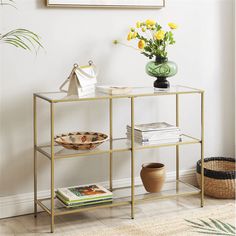 a vase with yellow flowers sitting on top of a metal shelf next to a basket