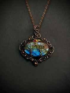 Blue Labradorite tree of life necklace pendant, Copper wire wrap family Tree, Tree of life pendant  Material: copper wire Details:  Pendant length: 2.5 x 3 inch  Color: blue & copper  This beautiful Tree of Life necklace is hand-crafted unisex necklace with Labradorite and copper wire; Tree of life pendant is hanged on the copper chain Labradorite is a mystical stone. He is a strong amulet. Mineral will help to open the destination, show talents, climb the career ladder, fulfill innermost desires, find love. Labradorite gives strength and resistance to stressful situations. Labradorite has the ability to act soothingly on a person, smoothing out experienced fears and unpleasant memories. The healing properties of the Labrador stone will be useful for both men and women. For men, stone help Tree Of Life Pendant For Jewelry Making, Unique Tree Of Life Pendant Necklace, Unique Tree Of Life Round Pendant Jewelry, Unique Tree Of Life Jewelry Gift, Bohemian Copper Wire Pendant Jewelry, Bohemian Tree Of Life Pendant Jewelry, Artistic Copper Jewelry With Soldered Details, Adjustable Tree Of Life Pendant Jewelry, Unique Copper Wire Pendant Jewelry