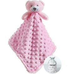 a pink teddy bear blanket with a tag on it's side next to a white package