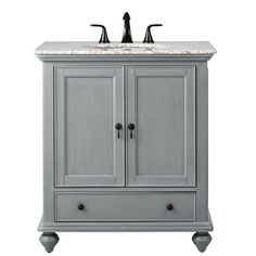 a white bathroom vanity with marble top and two faucets on the sink area