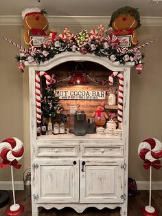 an old hutch decorated for christmas with candy canes and candies on top