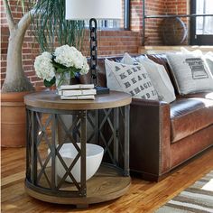 a living room with a couch, table and potted plant on the coffee table