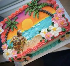 there is a cake decorated with flowers and a turtle