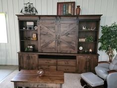 a living room with a large wooden entertainment center