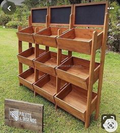 a wooden shelf with chalkboard on the top and shelves below it, in front of a sign that says pallet's designs