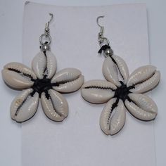 The Cowrie Shell Was Used As The First Form Of Currency In Africa. These Shells Have Been A Customer Favorite For 17 Years. These Earrings Are Fun, Playful And A Nice Accent To Any Outfit. Origin Of Beads: Kenya Elegant Flower Shaped Earrings For Beach, Elegant Flower-shaped Beach Earrings, Elegant Flower-shaped Earrings For Beach, Bohemian Beach Earrings With Handmade Flowers, Bohemian Earrings With Handmade Flowers For Beach, Bohemian Handmade Flower Earrings For Beach, White Flower Jewelry For Vacation, Elegant White Flower Earrings For Beach, Handmade Flower Earrings For Beach