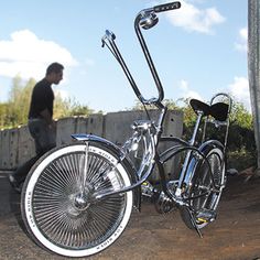 a man standing next to a parked bike