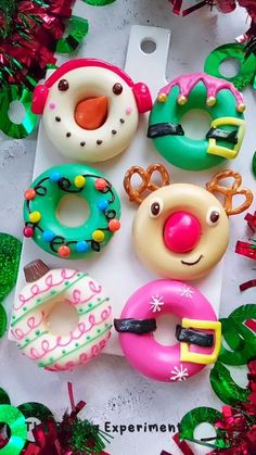 there are many doughnuts in the shape of animals and reindeer faces on this table