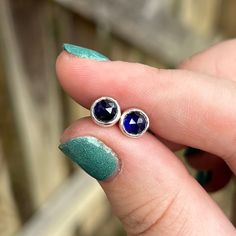 Simply Bold introduces to you one of a kind Sapphire post earrings featuring round, rose cut, blue Sapphire stones set in fine silver bezels. These stones are a gorgeous deep blue, and are rose cut making them sparkle off of the ear. They are also a great everyday post earring.  I used a 24 gauge sterling back plate and nice and sturdy long sterling posts for comfort in the ear. They also come with strong and secure backings to make sure an earring isn't lost. These earrings are small and dainty Faceted Sterling Silver Earrings Fine Jewelry, Teardrop Sapphire Earrings For Gift, Sapphire Gemstone Earrings As Gift, Sapphire Gemstone Earrings For Gift, Nickel Free Sapphire Earrings, Sapphire Earrings For Gifts, Nickel-free Sapphire Round Earrings, Blue Round Faceted Earrings, Blue Faceted Round Earrings