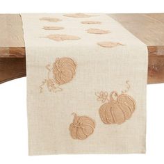 an embroidered table runner with pumpkins on it