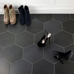 three pairs of shoes sitting on the floor next to each other