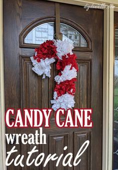 a candy cane wreath sitting on the front door of a house with text overlay