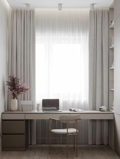 a white desk and chair in front of a window