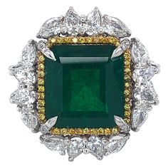 Stunning impressive ring set with a big Colombian emerald and diamonds. Colombian Emerald Minor 11.46 ct Gubelin certified,Minor Pear Shaped diamonds 2,7 Ct Brilliant cut diamonds 0,81 Ct Fancy yellow brilliant diamonds 0,77 Ct Material: 18 kt white gold Ring size: european 57 ( can be adjusted ) Total weight: 21.8 gram Diameter Head of ring: 25.1 mm Green Diamond Ring With Diamond Accents, Green Emerald-cut Cluster Ring With Diamond Accents, Emerald Cut Green Cluster Ring With Diamond Accents, Green Diamond Ring For Formal Occasions, Green Emerald Cut Diamond Gemstones, Green Diamond Platinum Ring With Prong Setting, Green Emerald Ring With Diamond Accents In Platinum, Platinum Emerald Ring With Diamond Accents, Platinum Green Diamond Ring