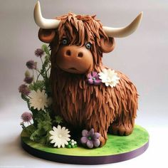 there is a cake made to look like a cow with horns and flowers on it