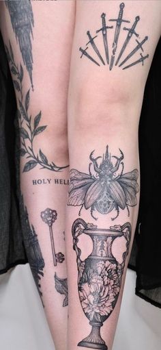 two tattoos on both legs, one with a bee and the other with flowers in vases