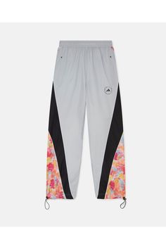 A bold cover-up for evening jogs or studio wear, these TrueCasuals woven trackpants from adidas by Stella McCartney are crafted from 100% recycled materials  elevated athleisure that is kinder to Mother Earth.     Color: Active Gold/Tactile Yellow/Clear Onix -Gray with multicolor panel inserts  Woven water-repellent adidas Primegreen fabric made with recycled materials  adidas by Stella McCartney logo print  Elasticated waistband  Stretch cuffs and hem     adidas Primegreen is made with a series Elevated Athleisure, Stella Mccartney Logo, Earth Color, Adidas By Stella Mccartney, Stella Mccartney Adidas, Athletic Wear, Sport Pants, Mother Earth, Active Wear For Women