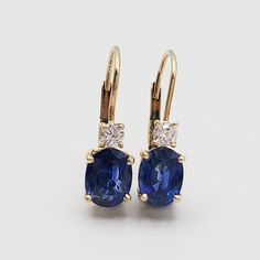 Beautiful pair of 14k yellow gold and sapphire earrings with diamond accents. The sapphires are a dreamy, pure, deep blue. I have the official jewelry appraisal from the first and only owner, see the last photo. These earrings were valued at $3625 in 1999. 2 oval cut blue sapphires, 2.59 carats, total weight between the two earrings. Fine color. 2 round brilliant diamonds. 0.10 carats each. Graded SI clarity, H color. Stones set in 4 prong baskets. ¾" long. 5.5 mm wide. 0.08 troy ounces or 2.3 grams. Sapphire Diamond Earrings, Sapphire And Diamond Earrings, Jewelry Appraisal, Color Stones, Sapphire Earrings, Sapphire Diamond, Color 2, Stone Settings, Vintage Watches