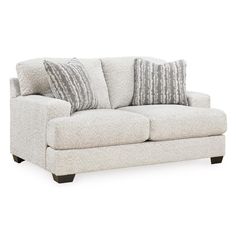 a white couch with two pillows on it