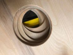 a yellow and black object sitting on top of a wooden table