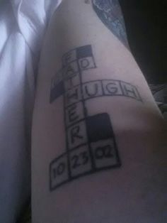 a person with a cross tattoo on their leg that says laugh, laugh, laugh