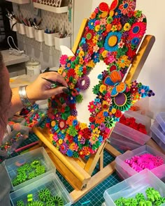 a person working on an art project with plastic flowers