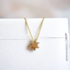 Elegant Star of David Necklace: Timeless symbol of faith, crafted with precision. Pictured at 16" and 18" adjustable lengths. Sterling Silver 14K Gold Plate 16" + 2" 10mm diameter Sugar Bean Jewelry's complimentary packaging adds an extra special touch to your jewelry purchase. Our dainty glass bottle and pouch will showcase your piece with style and sophistication. Yellow Gold Star Of David Charm Necklace Gift, Yellow Gold Star Of David Charm Necklace, Yellow Gold Charm Necklace With Star Of David Charm, Dainty Star Of David Necklace With Adjustable Chain, Gold Plated Star Of David Necklace As Gift, Gold-plated Star Necklaces With Adjustable Chain, Gold Star Necklace With Adjustable Chain, Yellow Gold Star Charm Necklace With Adjustable Chain, Elegant Gold Star Of David Charm Necklace