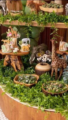 an assortment of stuffed animals and plants on display in a wooden stand with greenery