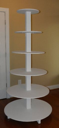 three tiered white cake stand on wooden floor