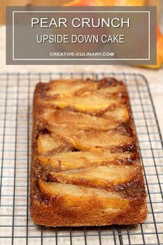 a piece of cake sitting on top of a cooling rack next to some peaches