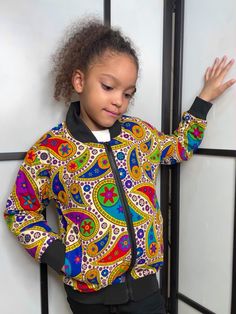 Check out these adorable bomber jackets for kids.  Beautifully designed with African Kente print, these bomber jackets for children are perfect for colder weather as they are well-insulated.  Buy now before they sell out!  If your child's size is not available now, the added bonus is that these jackets can be ordered so that they are custom made to fit your child perfectly.  We can make any size including plus size.  Purchase as displayed or change the  design! The choice is yours! Style: Casual Colour: Multi-coloured Unisex Pattern Type: All over print / African Kente print / geometric / graphic Length: Regular Season: All Type: Bomber jacket Details: Fully lined / pockets / zipper Fit Type: Regular / true to size fit Size: Any size including plus size can be custom made Neckline: Basebal Multicolor Cartoon Print Outerwear For Fall, Fall Multicolor Outerwear With Cartoon Print, Fall Multicolor Cartoon Print Outerwear, Multicolor Cartoon Print Outerwear With Long Sleeves, Multicolor Cartoon Print Long Sleeve Outerwear, Multicolor Long Sleeve Outerwear With Cartoon Print, Playful Long Sleeve Streetwear Outerwear, Kente Print, Dashiki Dress