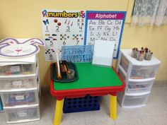 there is a desk with numbers on it and plastic bins in front of it