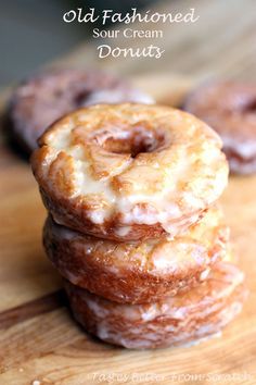 three glazed doughnuts stacked on top of each other with the words old fashioned sour cream donuts