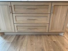 a kitchen with wooden floors and white counter tops on top of eachother's cabinets