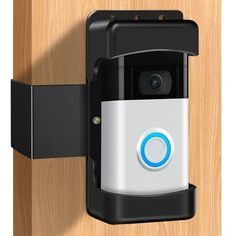 an electronic security camera mounted on a wooden door