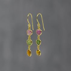 Tourmaline and Gold Vermeil Drop Earrings  Natural tourmaline gemstones - pinks, greens and browns - in a simple gold vermeil setting with a hook fitting.  Tourmaline is the birthstone for the month of October.  Dimensions (approx): * Length: 4.5cm including hook  * Width: 0.8cm  Materials: * Gold Vermeil  * Tourmaline* *Please note that these are raw, natural tourmaline gemstones which will vary slightly in size, shape and colour.   Beyond Biasa creates unique jewellery that is inspired by anti Round Tourmaline Gemstone Earrings, Elegant Tourmaline Earrings With Natural Stones, Tourmaline Multi-stone Earrings As Gift, Tourmaline Multi-stone Earrings For Gift, Multi-stone Tourmaline Earrings As A Gift, Tourmaline Drop Earrings, Brown Tourmaline, Coral Drop Earrings, Schmuck Gold