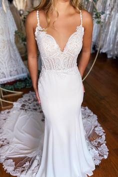 a woman in a white wedding dress posing for the camera