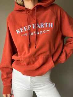 "Upcycled vintage terracotta colored oversized Champion hoodie sweatshirt with baby blue Keep Earth Vintage logo embroidered by small, woman-owned embroidery artist. By purchasing this item, you are supporting a small business, a local embroidery artist and saving a piece of clothing from potentially ending up in a landfill or incinerator while receiving a one-of-a-kind sweatshirt! 80% cotton | 20% polyester | XL Recommended for size M-XXL depending on desired drape & styling but please always r Spring Vintage Hoodie With Relaxed Fit, Vintage Relaxed Fit Hoodie For Spring, Organic Cotton Hoodie Sweatshirt With Drawstring, Vintage Hooded Top With Relaxed Fit, Vintage Cotton Sweatshirt With Kangaroo Pocket, Vintage Cotton Hoodie With Letter Print, Vintage Hooded Hoodie For Spring, Casual Organic Cotton Sweatshirt With Drawstring Hood, Vintage Long Sleeve Hoodie With Letter Print